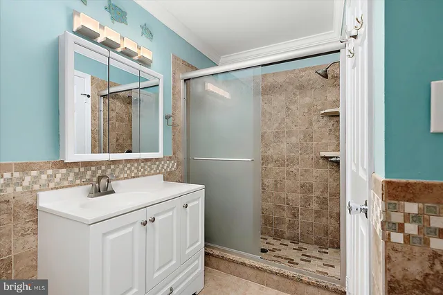 a bathroom with a sink a shower and a mirror