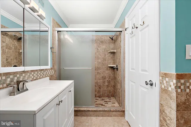 a bathroom with a sink mirror and shower