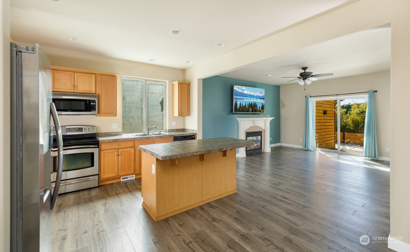 7365 Radius Loop Southeast Lacey, WA 98513 - Photo 13 of 24 a kitchen with stainless steel appliances a stove top oven and a refrigerator