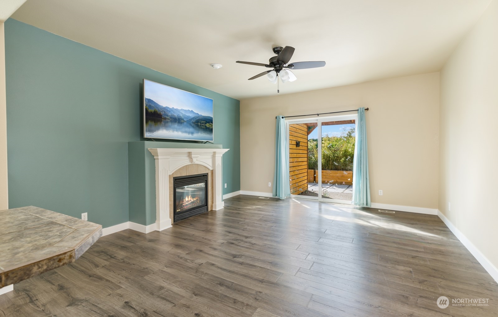 7365 Radius Loop Southeast Lacey, WA 98513 - Photo 14 of 24 a view of an empty room with wooden floor fireplace and a window