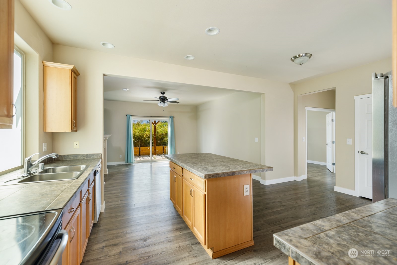 7365 Radius Loop Southeast Lacey, WA 98513 - Photo 15 of 24 a kitchen with granite countertop a stove oven and a refrigerator