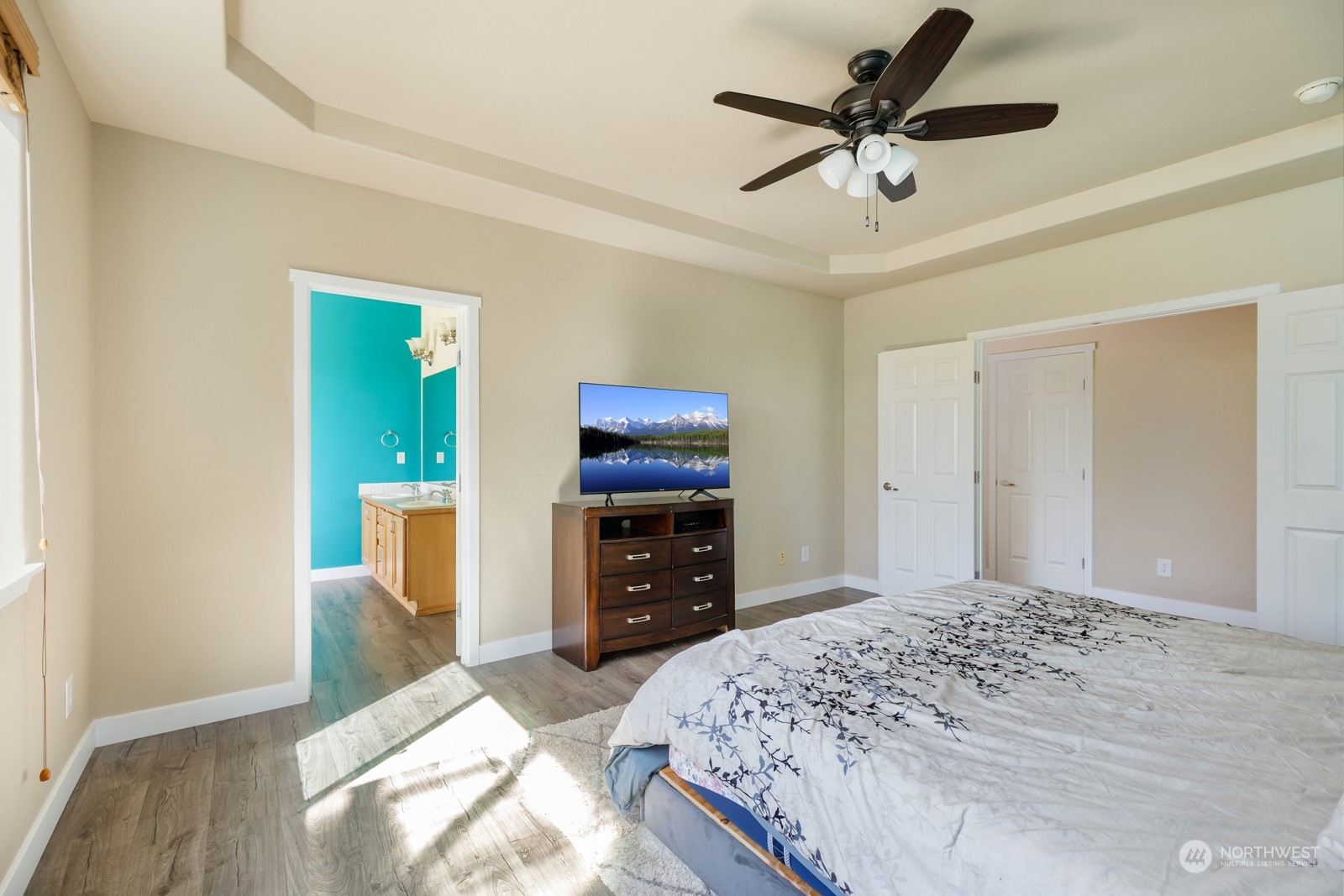 7365 Radius Loop Southeast Lacey, WA 98513 - Photo 18 of 24 a bedroom with a bed and a chandelier
