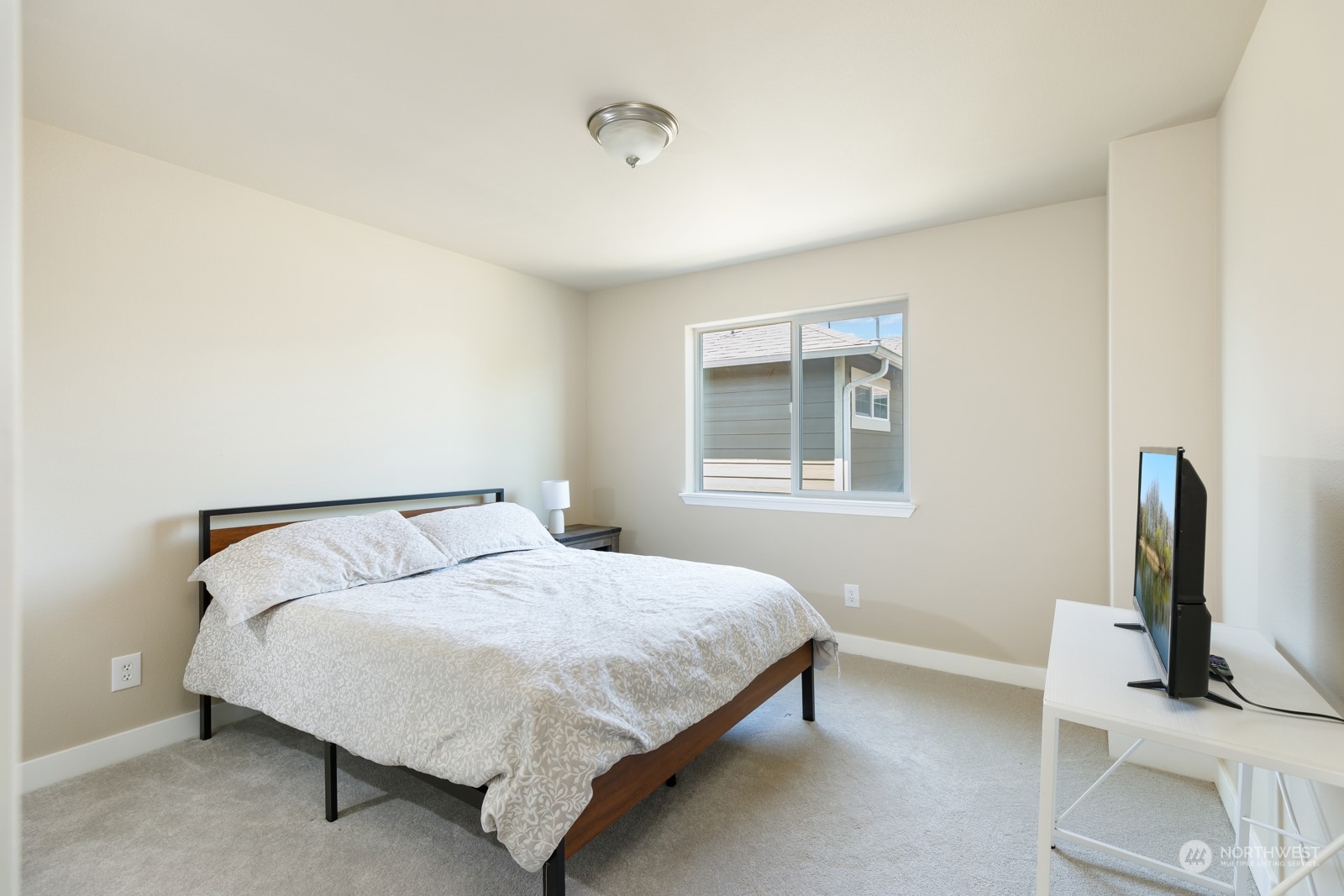 7365 Radius Loop Southeast Lacey, WA 98513 - Photo 23 of 24 a bedroom with a bed table and a window