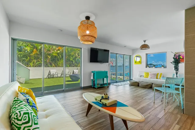 a view of yard from deck with patio