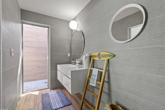 a bathroom with a bathtub and a painting on the wall