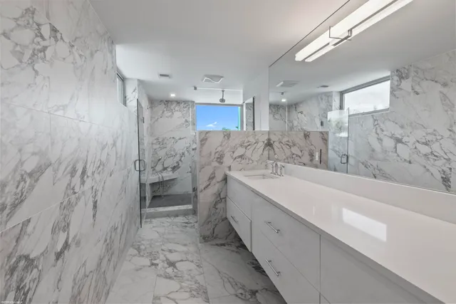 a view of a house with swimming pool and sitting area