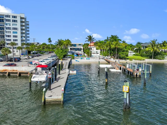 a view of a house with a yard and potted plants