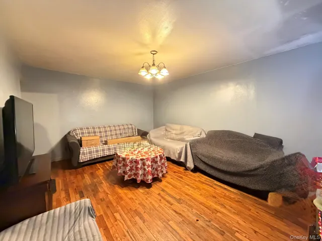 a bedroom with furniture and a wooden floor