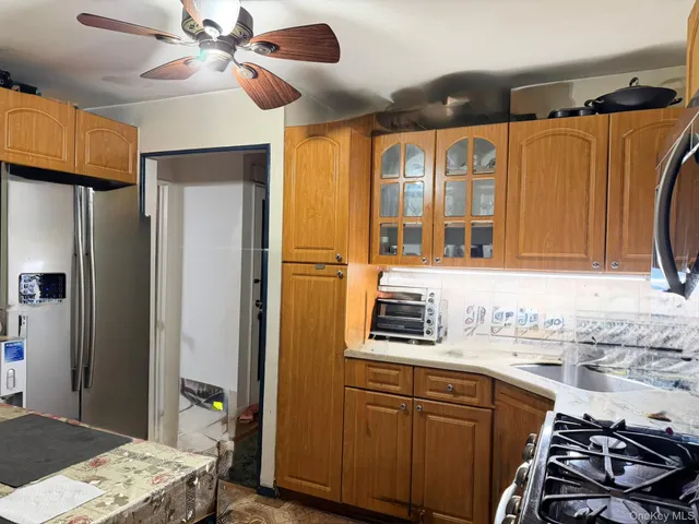 a kitchen with stainless steel appliances a sink stove and refrigerator