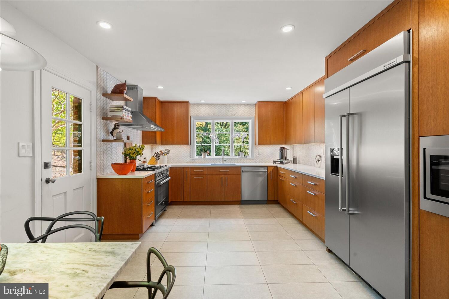 4838 Broad Branch Road Northwest Washington, DC 20008 - Photo 11 of 33 a large kitchen with a window a counter space and stainless steel appliances