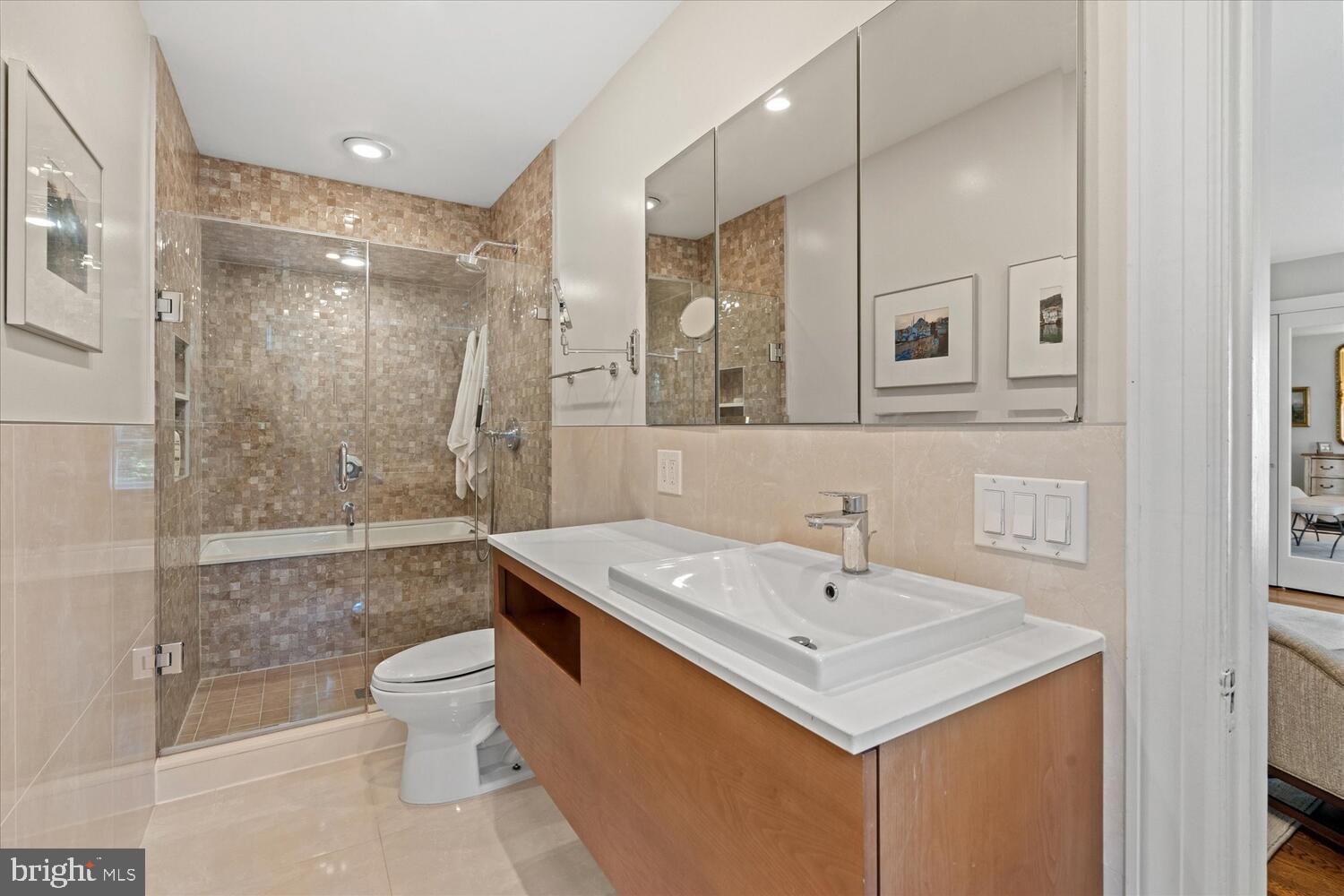 4838 Broad Branch Road Northwest Washington, DC 20008 - Photo 21 of 33 a bathroom with a sink a toilet and shower