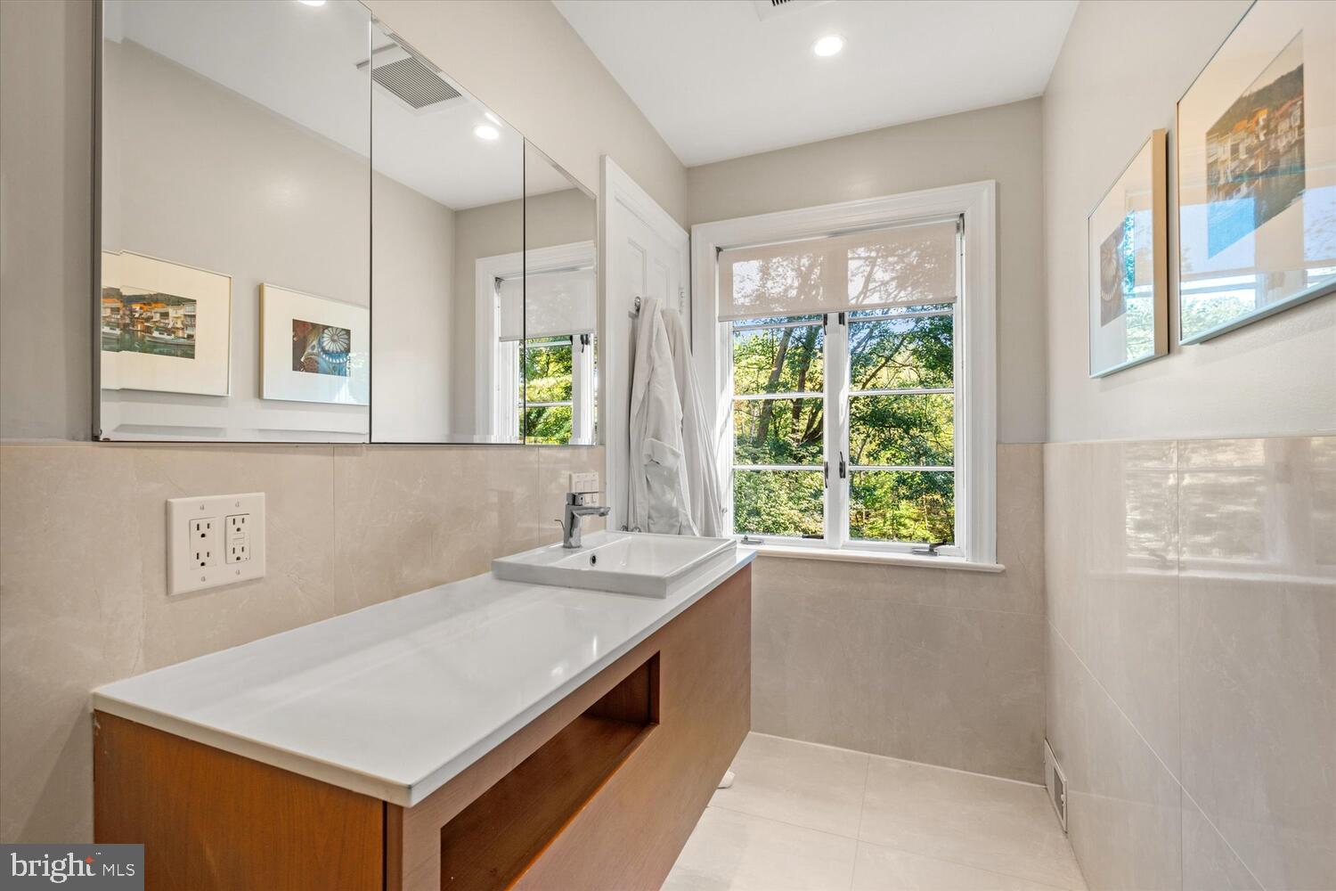 4838 Broad Branch Road Northwest Washington, DC 20008 - Photo 22 of 33 a bathroom with a sink a vanity and a large mirror