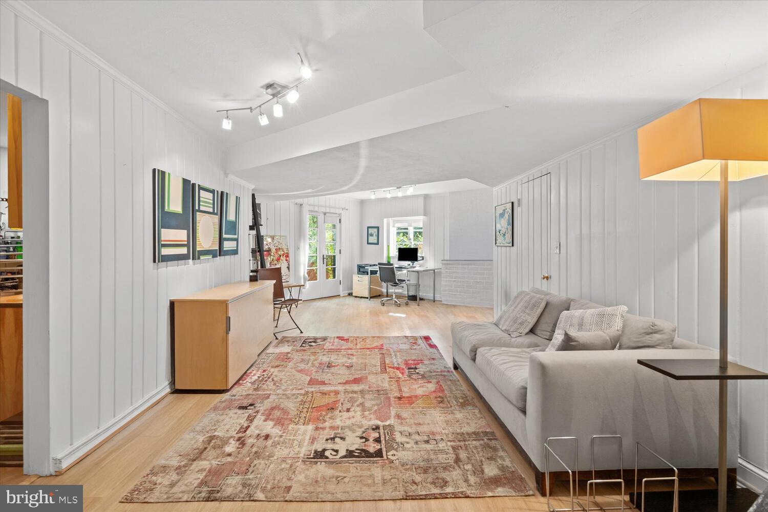 4838 Broad Branch Road Northwest Washington, DC 20008 - Photo 29 of 33 a living room with furniture and a dining table with wooden floor