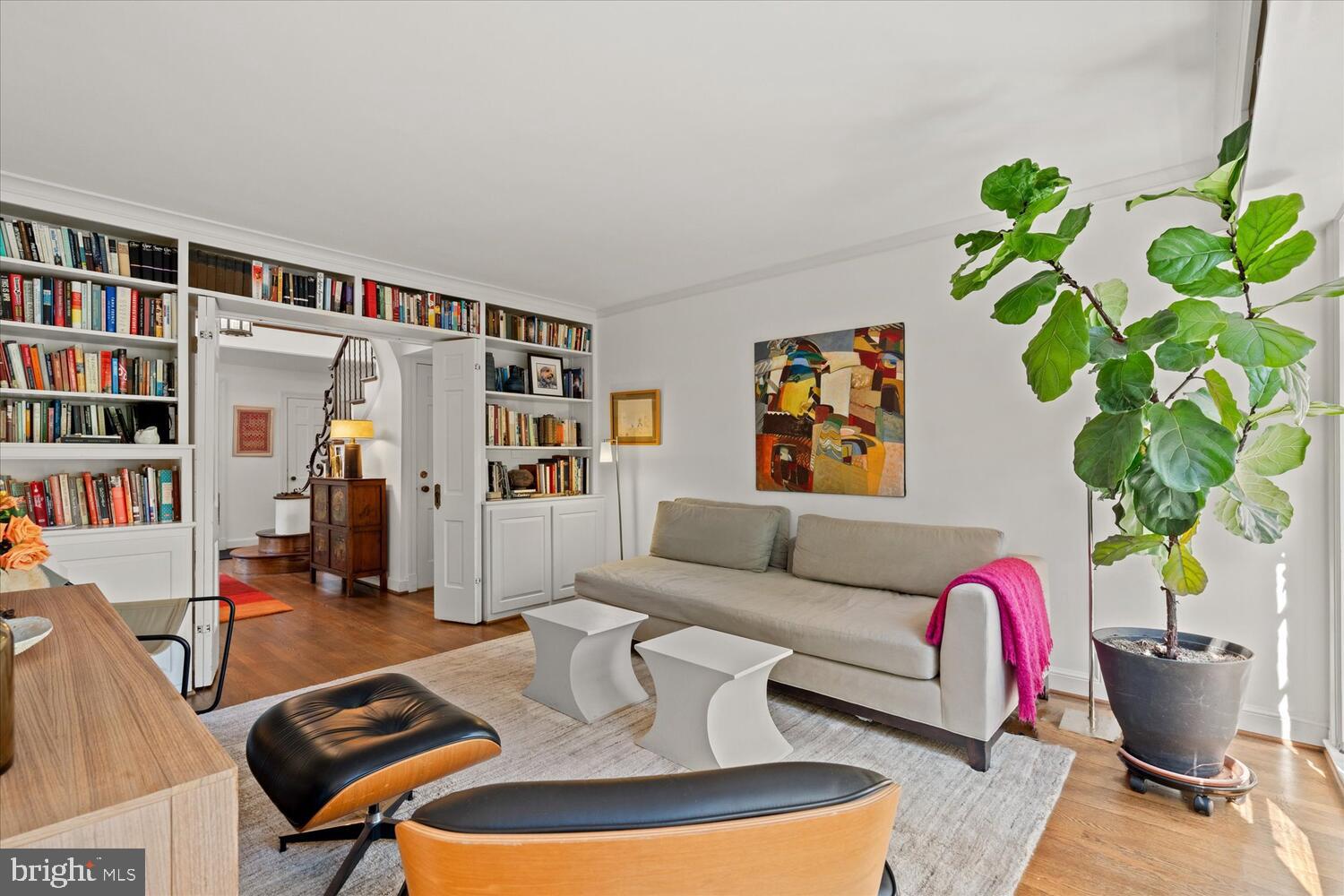 4838 Broad Branch Road Northwest Washington, DC 20008 - Photo 8 of 33 a living room with furniture a bookshelf and a potted plant
