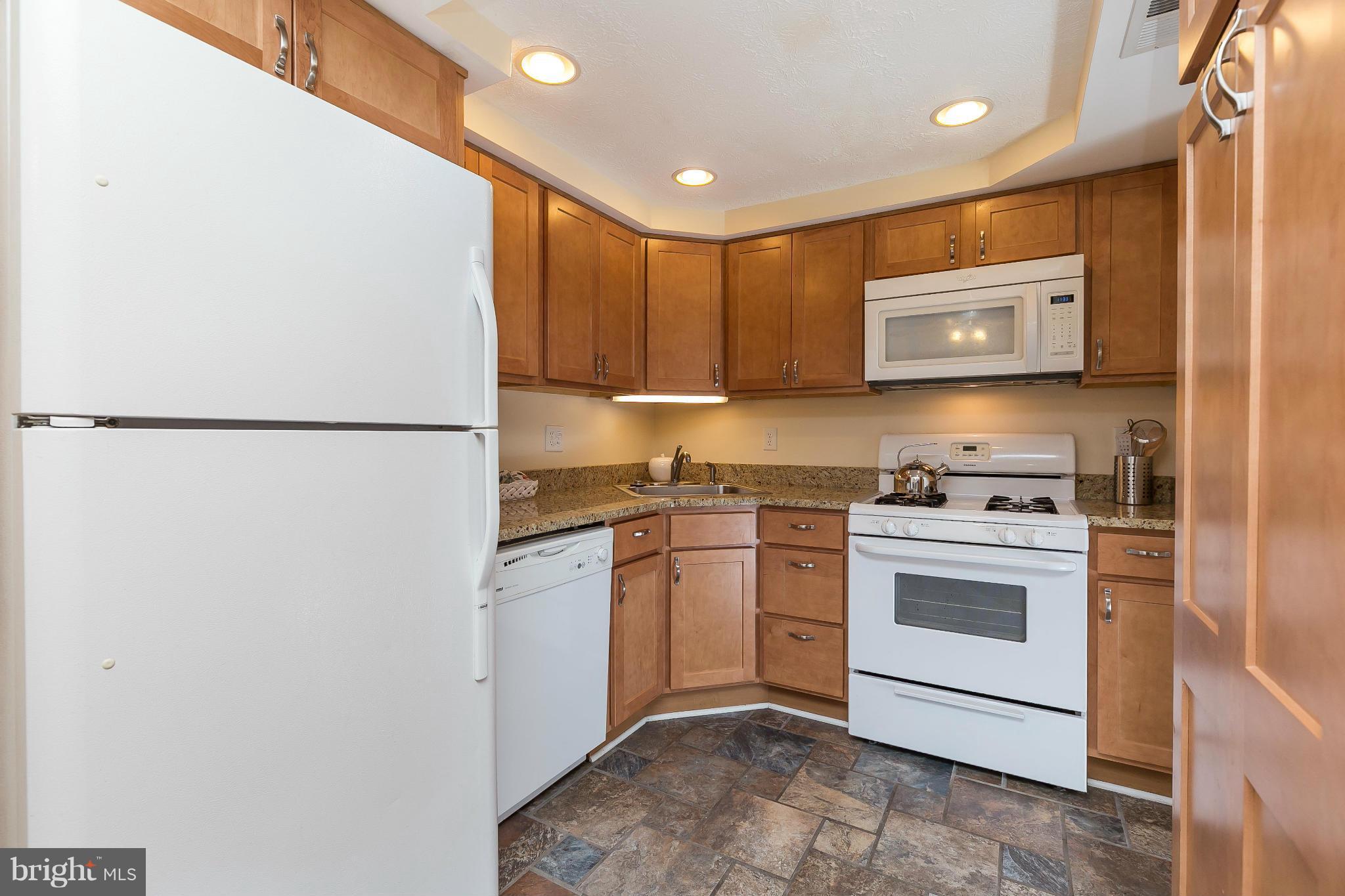 2572 Riva Road, Unit 4B Annapolis, MD 21401 - Photo 4 of 20 a kitchen with a refrigerator sink and stove
