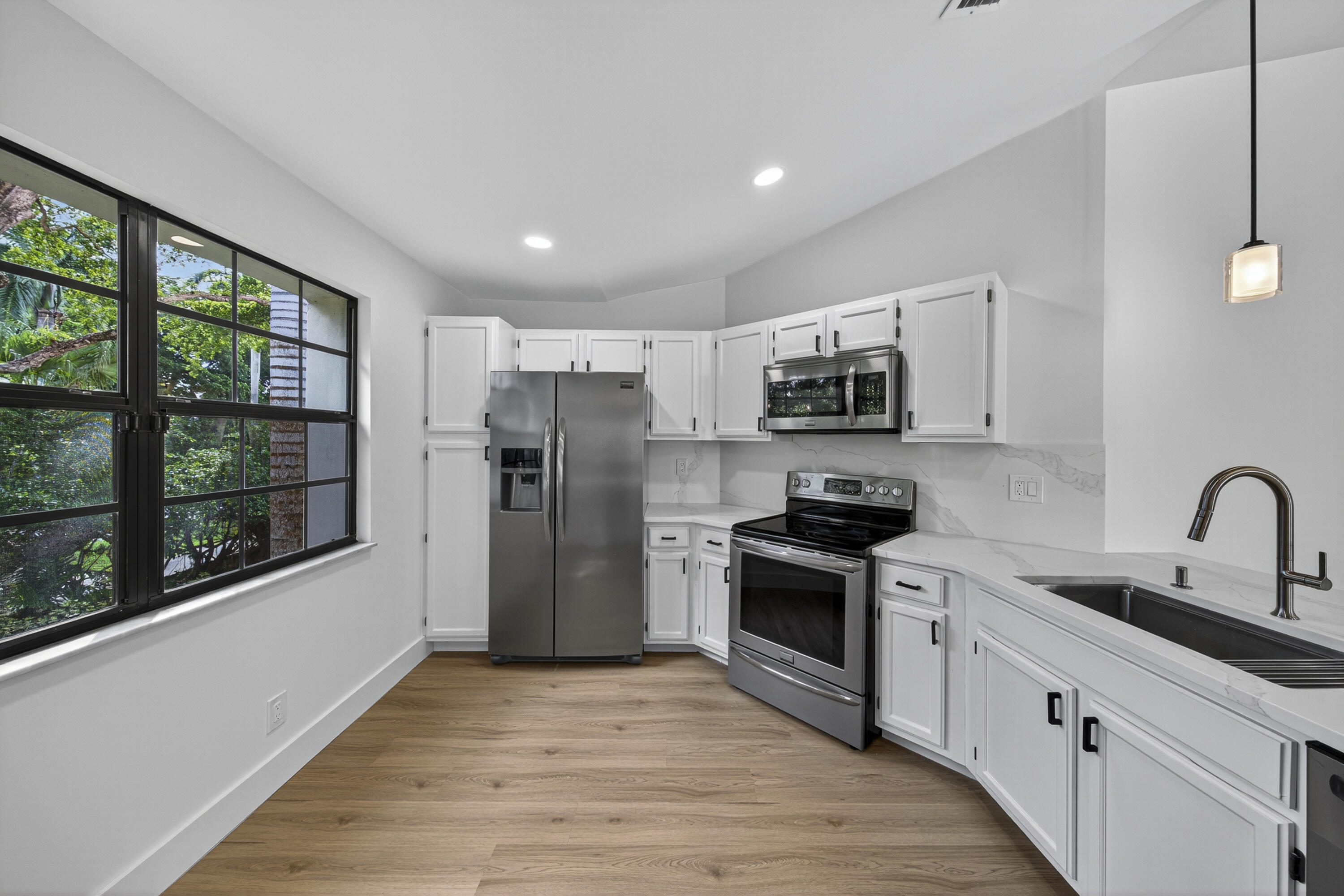 6040 Verde Trail South, Unit 3010 Boca Raton, FL 33433 - Photo 13 of 36 a kitchen with refrigerator a microwave a sink and cabinets