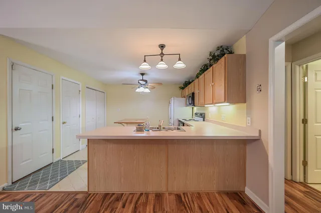 a kitchen with kitchen island a sink appliances and cabinets