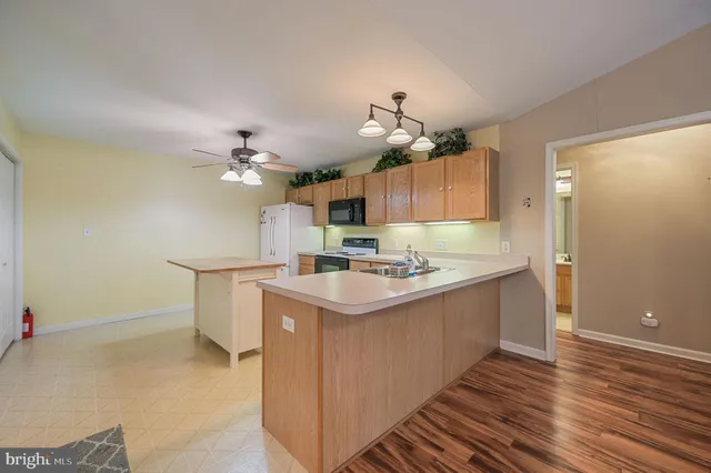 a kitchen with a sink cabinets and wooden floor