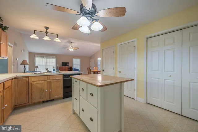 a kitchen with a sink and chandelier