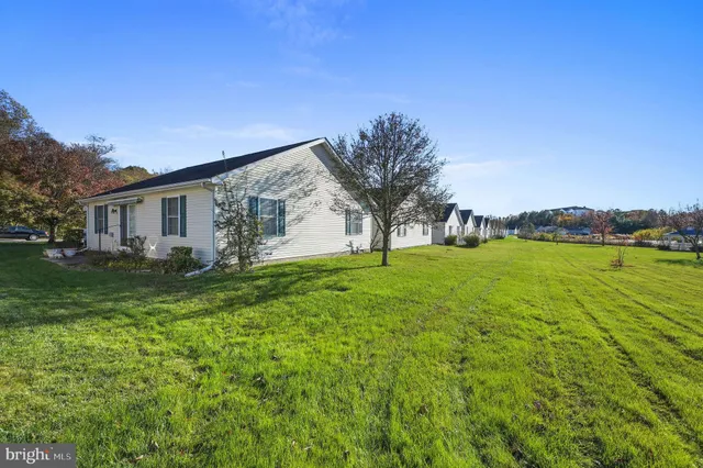 a view of house with backyard