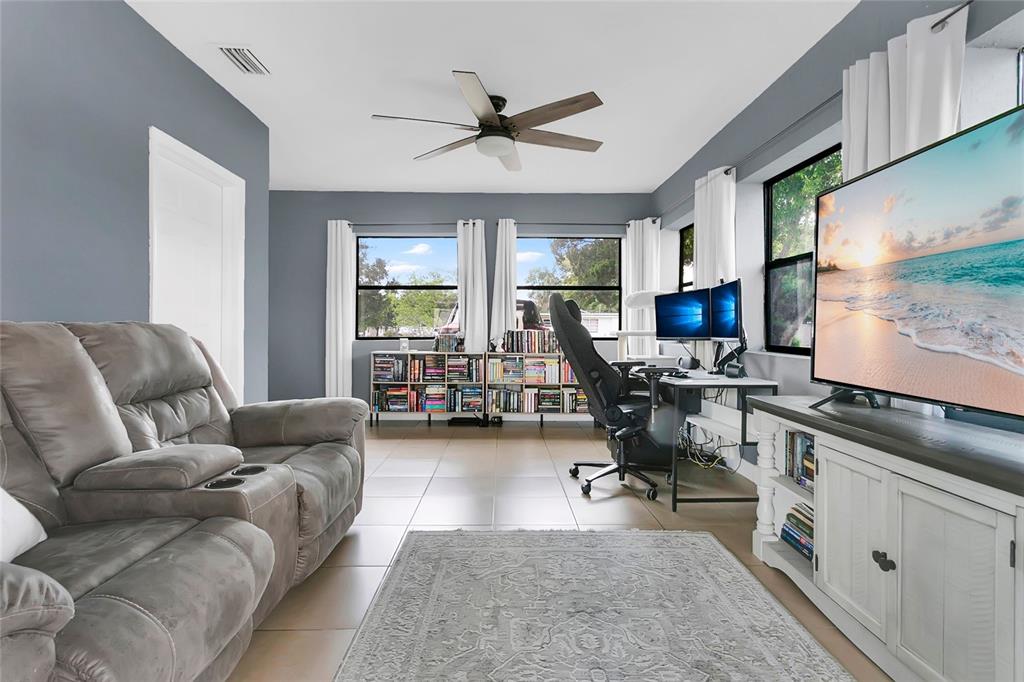 498 Clemson Drive Altamonte Springs, FL 32714 - Photo 17 of 31 a living room with furniture and a large window
