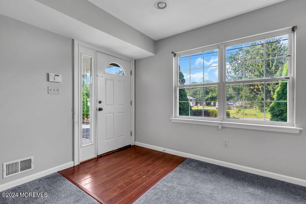 233 Timberline Road Toms River, NJ 08753 - Photo 4 of 38 an empty room with wooden floor and windows