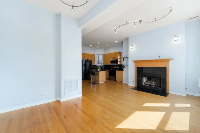 a kitchen with stainless steel appliances a refrigerator stove and microwave