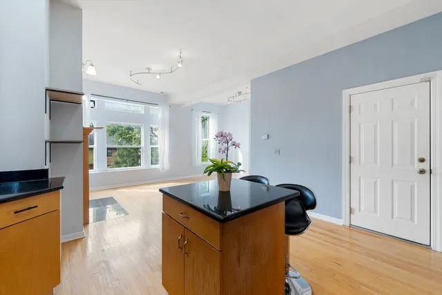 a kitchen with stainless steel appliances granite countertop a sink refrigerator and microwave