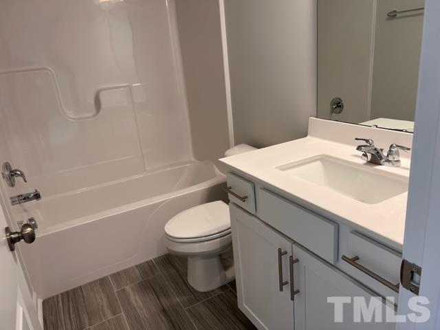 2403 Chert Lane, Unit 2403 Raleigh, NC 27610 - Photo 12 of 19 a bathroom with a sink toilet and shower