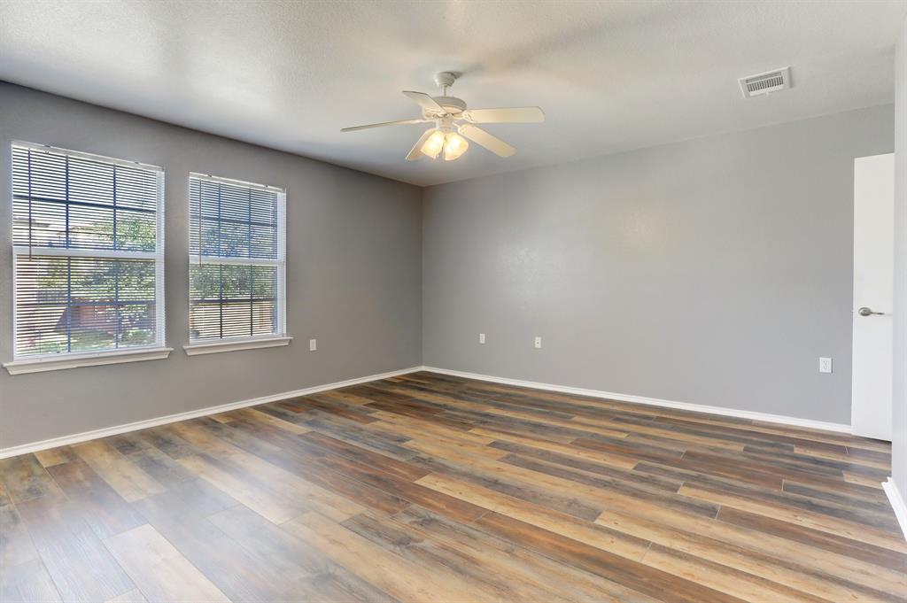 5913 Silver Screen Drive Austin, TX 78747 - Photo 12 of 31 a view of an empty room with wooden floor and a window