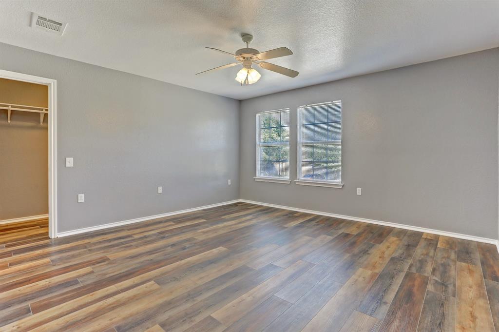 5913 Silver Screen Drive Austin, TX 78747 - Photo 14 of 31 a view of an empty room with wooden floor and a window