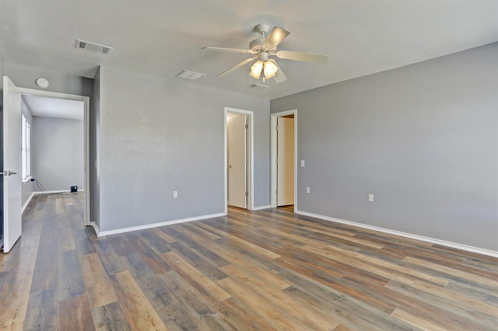 5913 Silver Screen Drive Austin, TX 78747 - Photo 15 of 31 wooden floor in an empty room with a chandelier