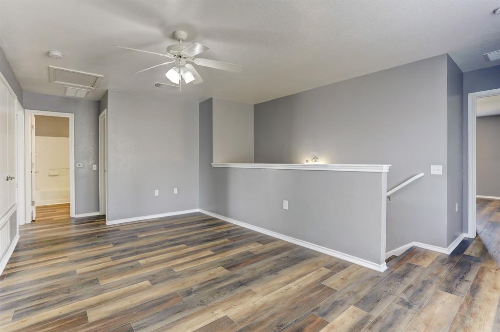 5913 Silver Screen Drive Austin, TX 78747 - Photo 18 of 31 a view of a livingroom with a ceiling fan and wooden floor