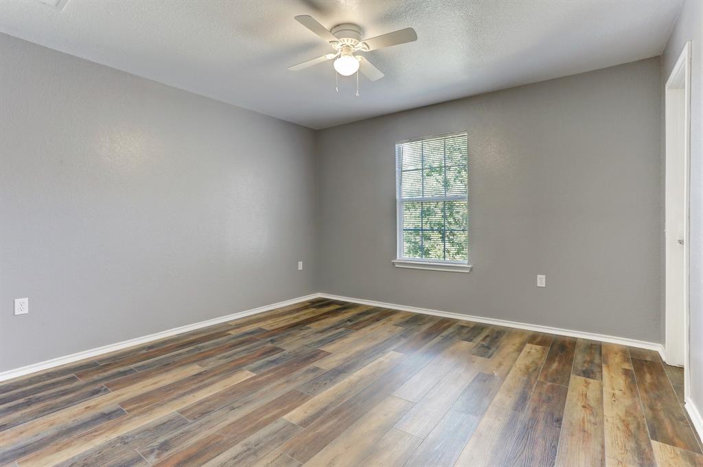 5913 Silver Screen Drive Austin, TX 78747 - Photo 19 of 31 wooden floor in an empty room with a window