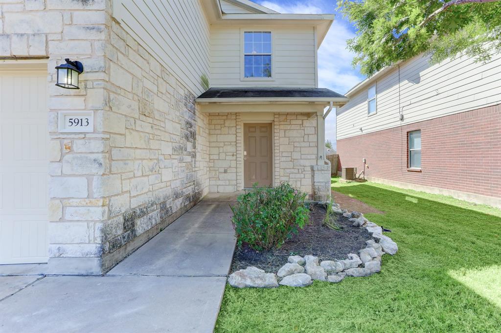 5913 Silver Screen Drive Austin, TX 78747 - Photo 2 of 31 a front view of a house with garden