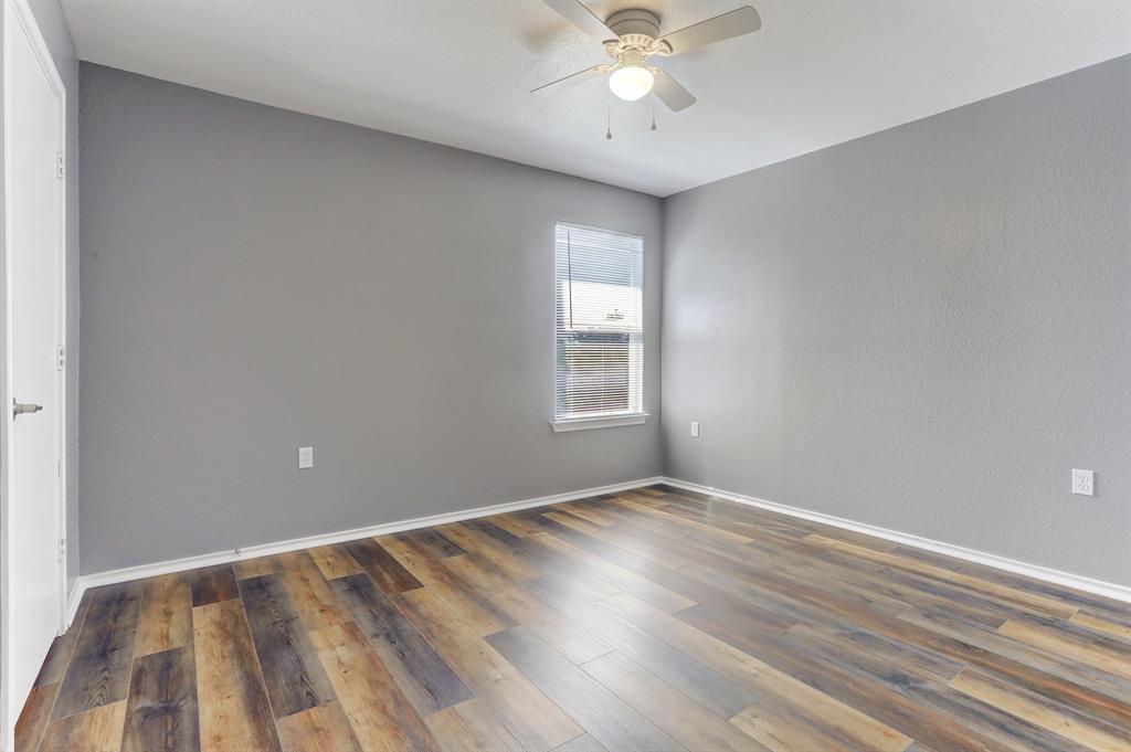 5913 Silver Screen Drive Austin, TX 78747 - Photo 22 of 31 wooden floor in an empty room with a window