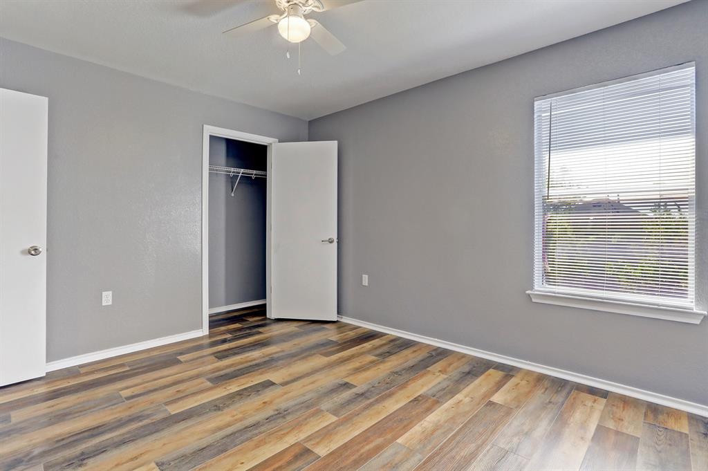 5913 Silver Screen Drive Austin, TX 78747 - Photo 23 of 31 a view of an empty room with wooden floor and a window