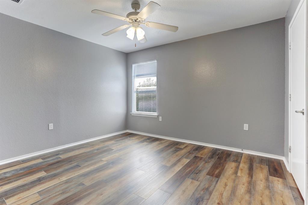 5913 Silver Screen Drive Austin, TX 78747 - Photo 25 of 31 wooden floor in an empty room with a window