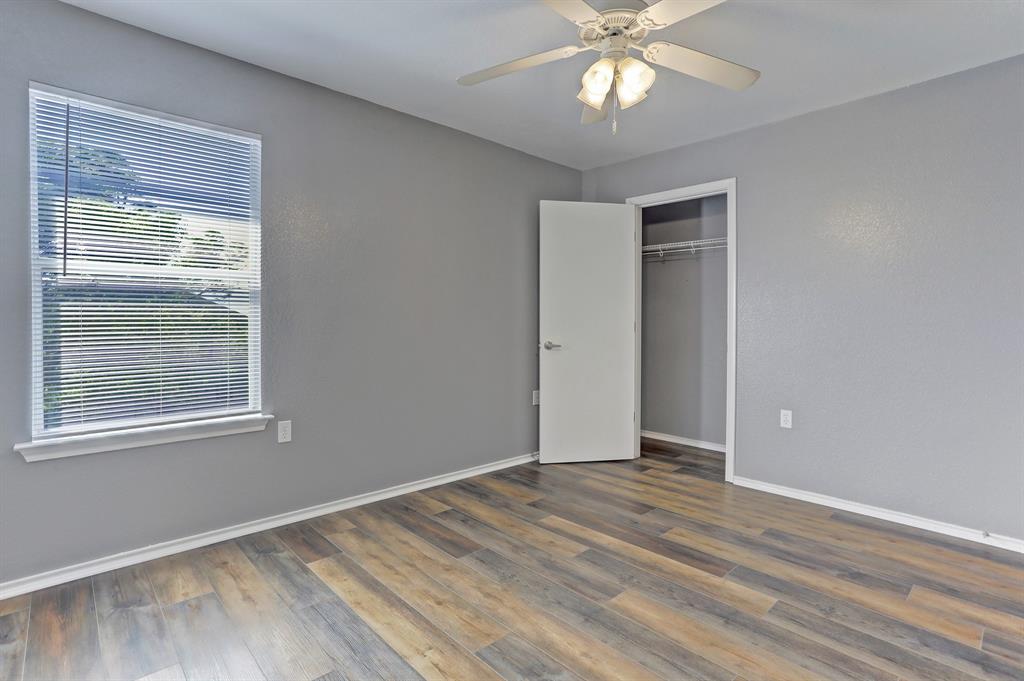 5913 Silver Screen Drive Austin, TX 78747 - Photo 26 of 31 a view of an empty room with wooden floor and a window