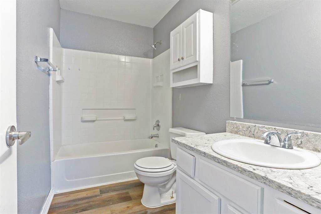 5913 Silver Screen Drive Austin, TX 78747 - Photo 28 of 31 a bathroom with a sink a toilet and shower