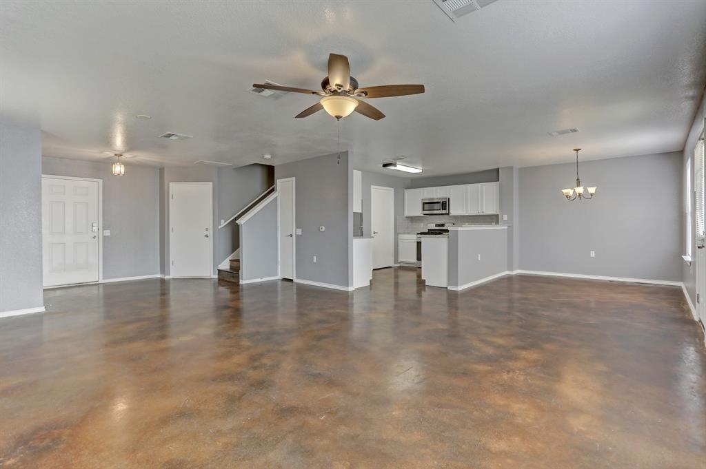 5913 Silver Screen Drive Austin, TX 78747 - Photo 4 of 31 a view of empty room with wooden floor and windows