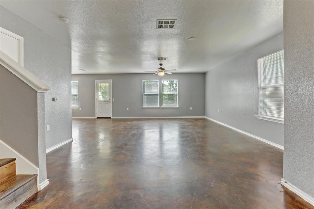 5913 Silver Screen Drive Austin, TX 78747 - Photo 7 of 31 an empty room with wooden floor and windows