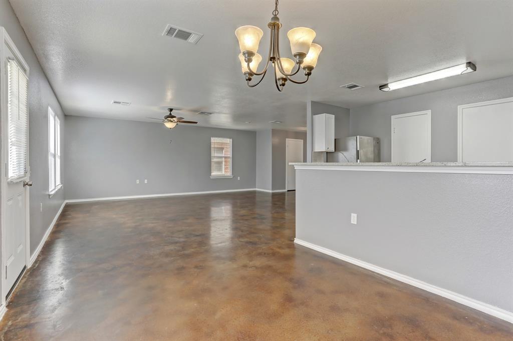 5913 Silver Screen Drive Austin, TX 78747 - Photo 10 of 31 en view interior of a house a chandelier fan wooden floor and chandelier