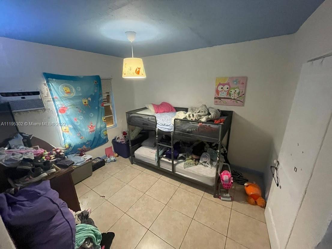 3040 Northwest 13th Avenue Miami, FL 33142 - Photo 11 of 51 a living room with furniture and a flat screen tv