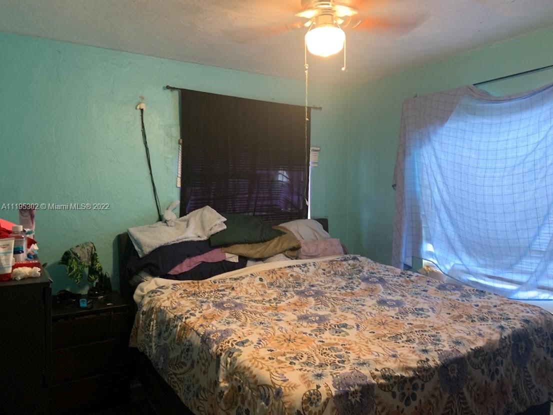 3040 Northwest 13th Avenue Miami, FL 33142 - Photo 14 of 51 a bedroom with a bed and a mirror