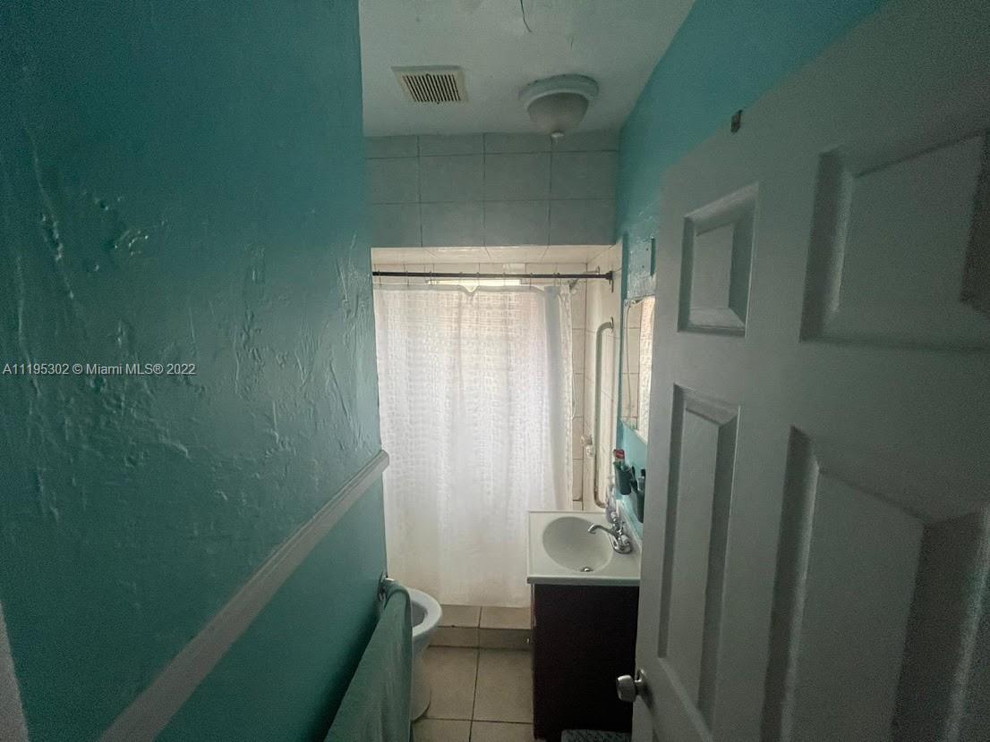 3040 Northwest 13th Avenue Miami, FL 33142 - Photo 16 of 51 a bathroom with a sink a toilet and shower
