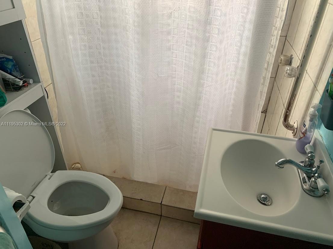 3040 Northwest 13th Avenue Miami, FL 33142 - Photo 19 of 51 a bathroom with a sink and a toilet