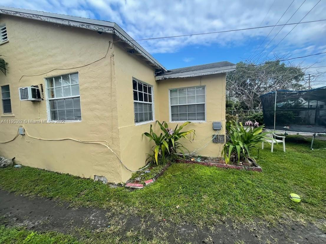 3040 Northwest 13th Avenue Miami, FL 33142 - Photo 26 of 51 a backyard of a house with table and chairs