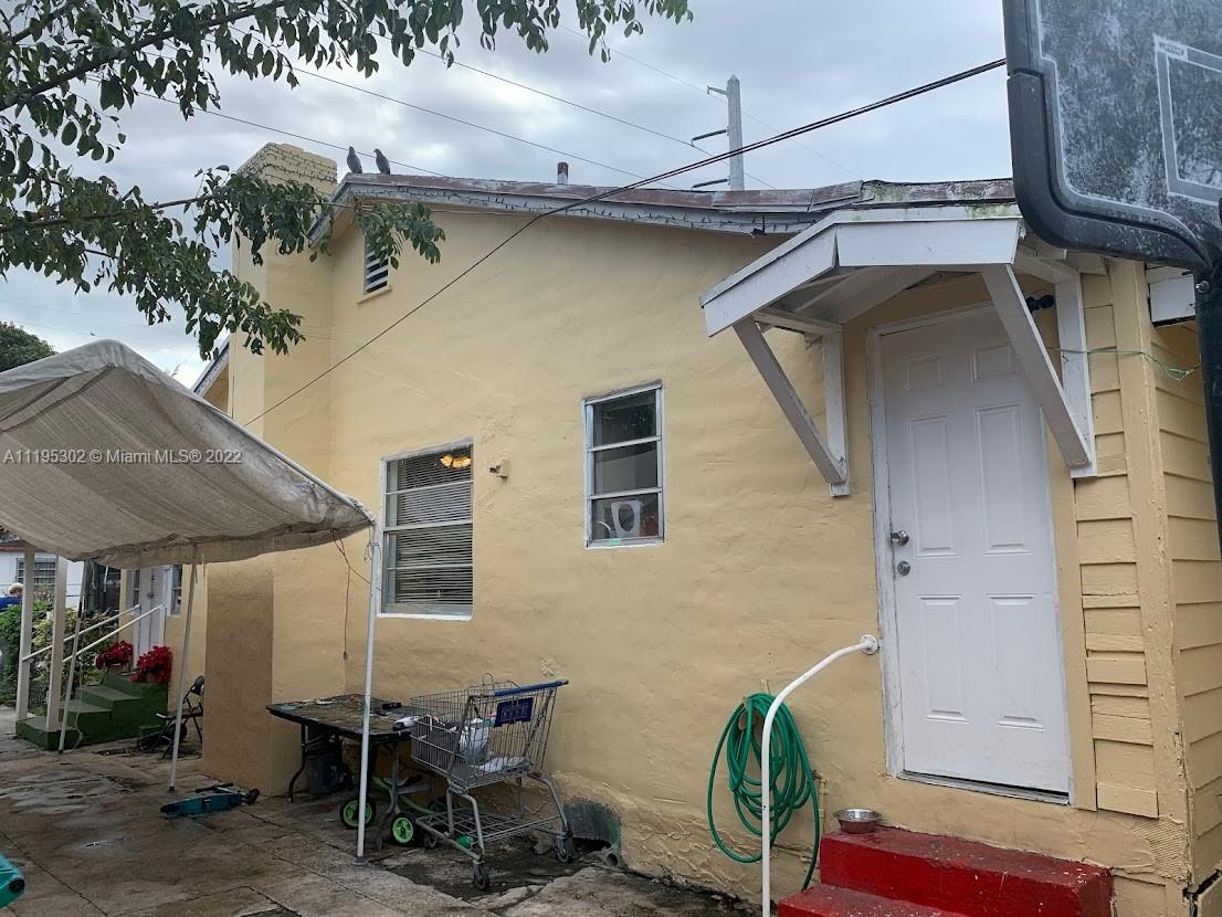 3040 Northwest 13th Avenue Miami, FL 33142 - Photo 28 of 51 a view of a patio with table and chairs