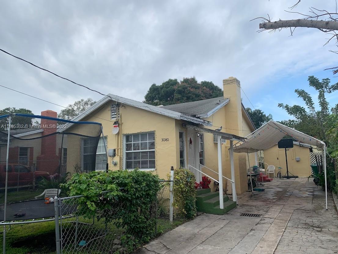 3040 Northwest 13th Avenue Miami, FL 33142 - Photo 29 of 51 a front view of a house with garden